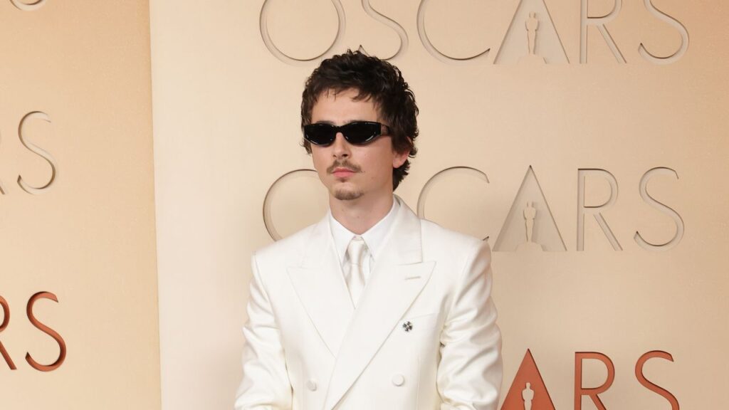Timothée Chalamet Goes Full Y2K Boy Band in a White Suit and Goatee on the 2026 Oscars Red Carpet