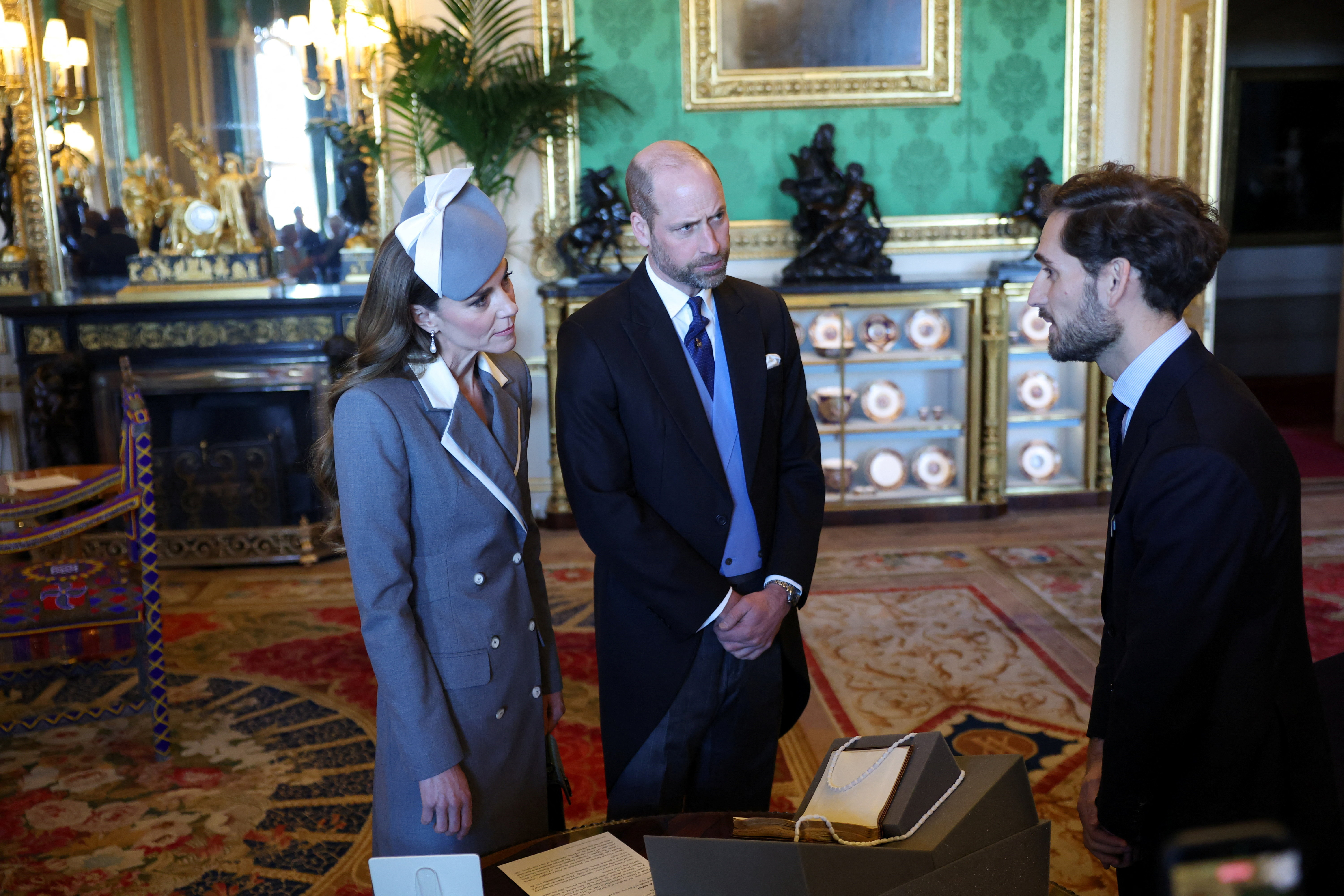 WINDSOR, ENGLAND - MARCH 18: Prince William, Prince of Wales and Catherine, Princess of Wales, view exhibits from the Royal Collection in the Green Drawing room on the first day of State Visit by The President of the Federal Republic of Nigeria on March 18, 2026 in Windsor, England. President Bola Tinubu and First Lady Oluremi Tinubu are conducting a historic State Visit to the United Kingdom, marking the first state visit by a Nigerian leader in 37 years and the first to be hosted at Windsor Castle. (Photo by Hannah McKay - WPA Pool/Getty Images)