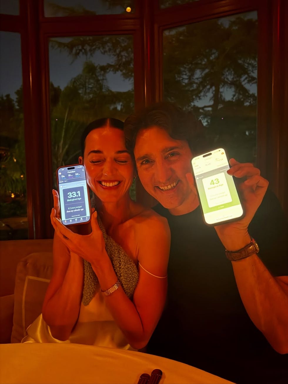 Two people holding their smartphones displaying health metrics. Two people holding their smartphones displaying health metrics.
