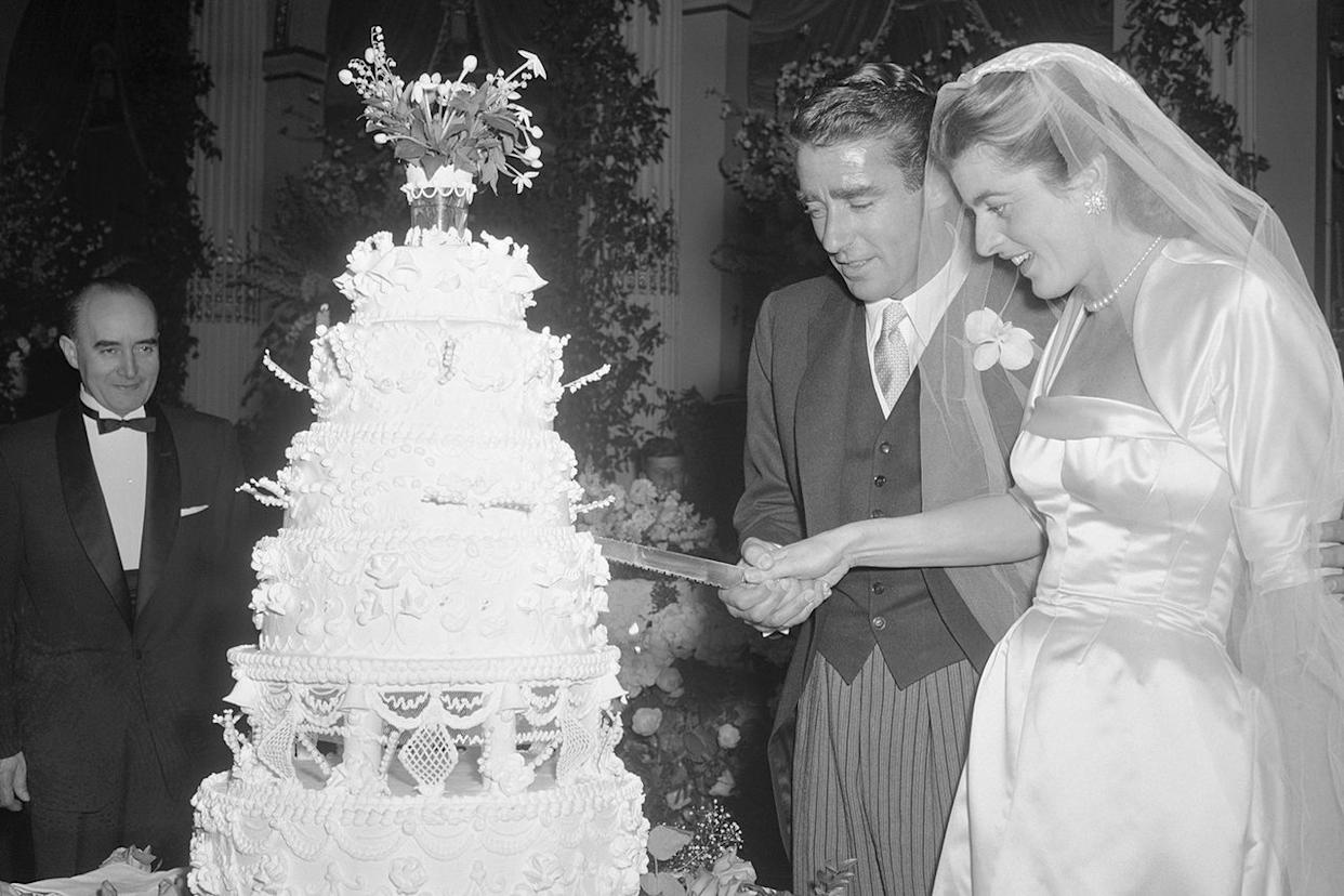 Patricia Kennedy, daughter of multi-millionaire former U.S. Ambassador to the court of St. James, Joseph P. Kennedy and husband Peter Lawford, Hollywood actor, cut their wedding cakeCredit: Bettmann/Getty