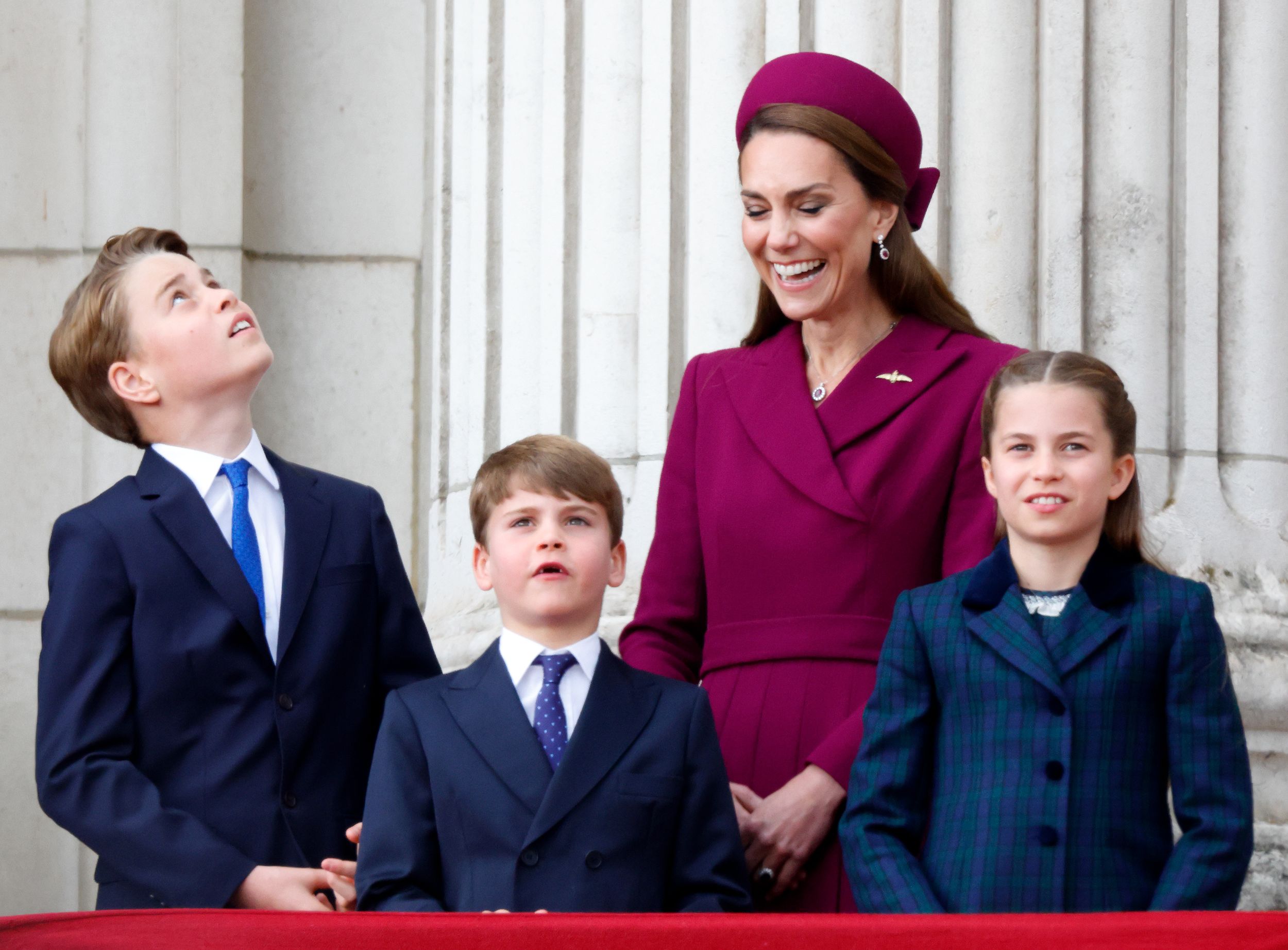 Prince George, Prince Louis and Princess Charlotte on the Buckingham Palace balcony as Kate Middleton laughs behind them