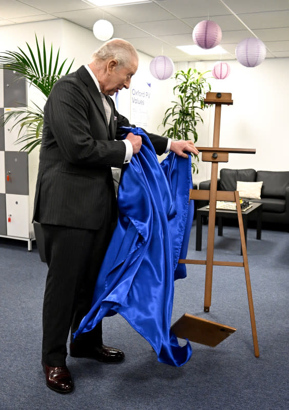 Britain's King Charles III reacts as he unveils a plaque which accidentally falls to the floor during a visit to Oxford Photovoltaics an enterprise developing advanced solar panels, in Kidlington, Oxfordshire, west of London on March 27, 2026. (Photo by Kate Green / POOL / AFP via Getty Images)Kate Green &sol; POOL &sol; AFP via Getty Images
