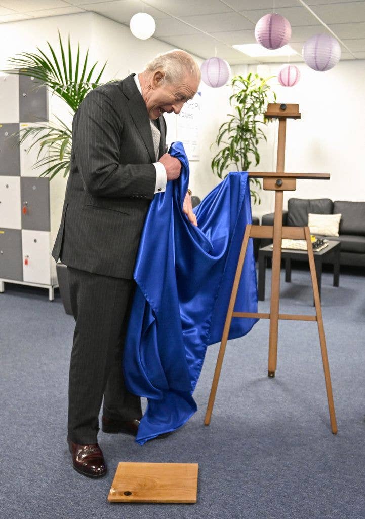 Britain's King Charles III reacts as he unveils a plaque which accidentally falls to the floor during aÂ visit to Oxford Photovoltaics an enterprise developing advanced solar panels, in Kidlington, Oxfordshire, west of London on March 27, 2026