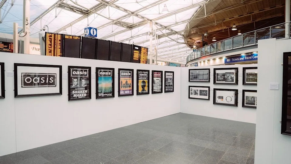 A pop-up Microdot Design exhibition featuring iconic 1990s Oasis artwork by Brian Cannon on display at Manchester Piccadilly train station