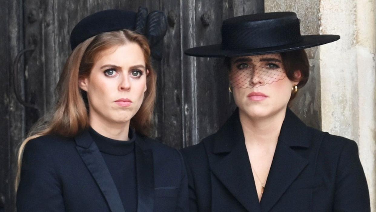 A close-up of the York sisters looking stern wearing all black.