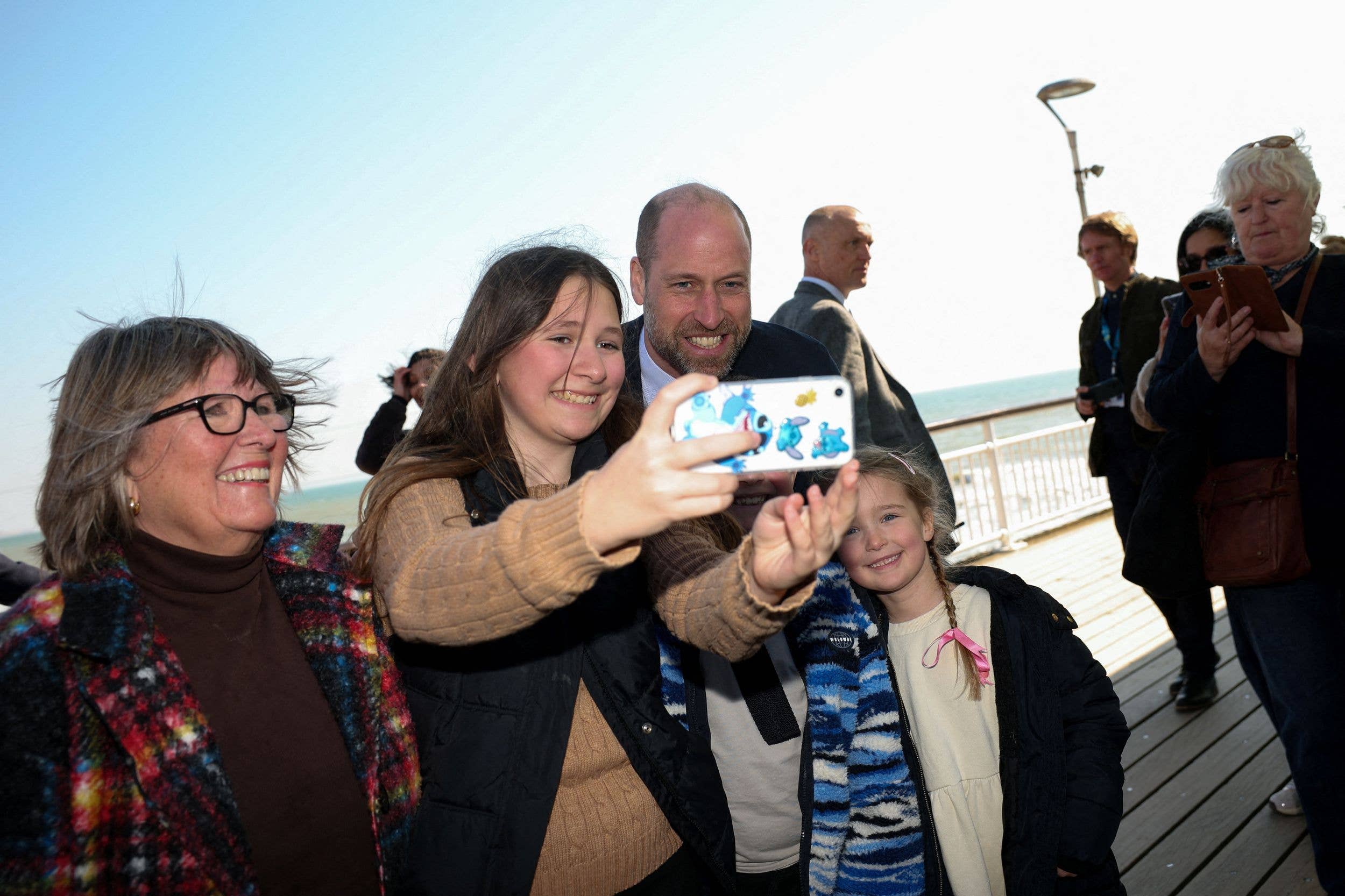 Prince William takes a selfie with a family on Bournemouth pier