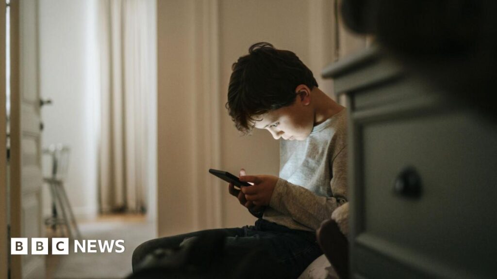 Don’t panic – five ways to stop your kids’ endless scrolling A boy stares down at a phone screen