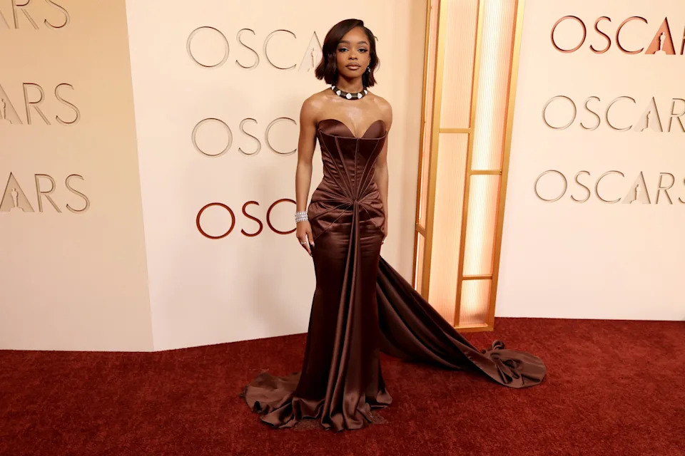 Marsai Martin arrived at the 2026 Academy Awards wearing a structured chocolate brown gown with a dramatic train.