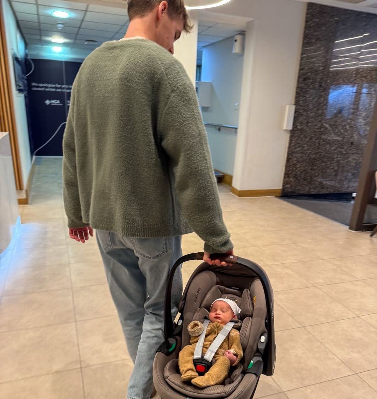 Joe was snapped holding his new son
