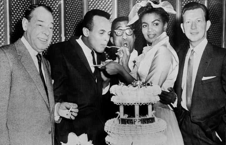 Sammy Davis Jr., 32, and Loray White, 23, cut and serve cake to close friends and celebrities immediately following their wedding in Las Vegas on Jan. 11, 1958. The guests are, left to right: Joe E. Lewis; best man, Harry Belafonte; Davis; White and Donald O'Connor. 