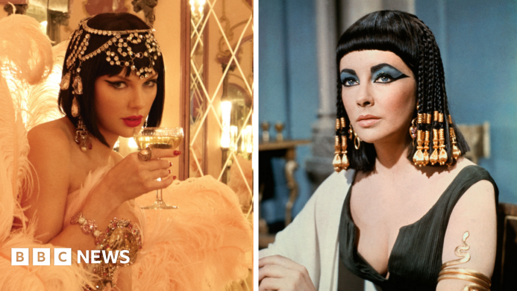 Taylor Swift pays homage to Elizabeth Taylor with surprise music video Taylor Swift and Elizabeth Taylor pictured in a split photograph. On the left, Swift is wearing a bejewelled headpiece and a black wig, while holding a glass of champagne to her lips. On the right, Elizabeth Taylor wears a similar wig, while posing on the set of her 1963 film Cleopatra.