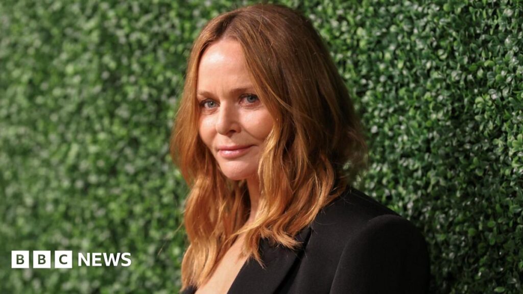 Stella McCartney’s Highland ‘forever home’ set for approval Stella McCartney has long blonde hair and is wearing a black suit. She is standing next to a green hedge.