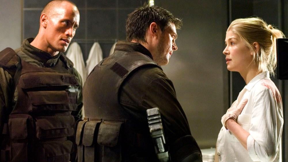 Rosamund Pike Says Her 2005 ‘Doom’ Movie With Dwayne Johnson Is ‘One of the Worst Films Ever Made’ and ‘Could’ve Ended My Career’