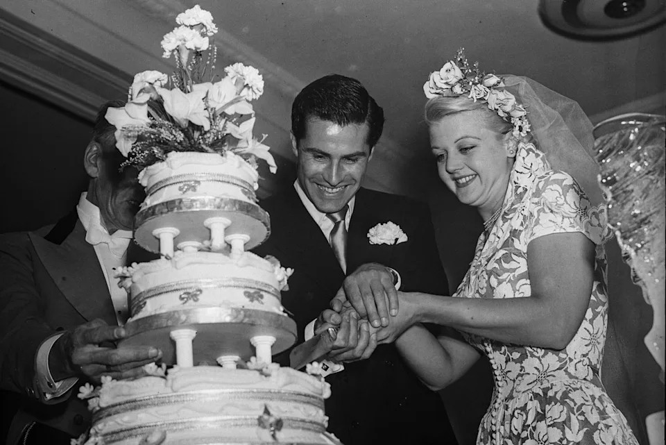 Peter Shaw and Angela Lansbury cut the cake at their wedding on Aug. 12, 1949Credit: Walter Bellamy/Express/Getty