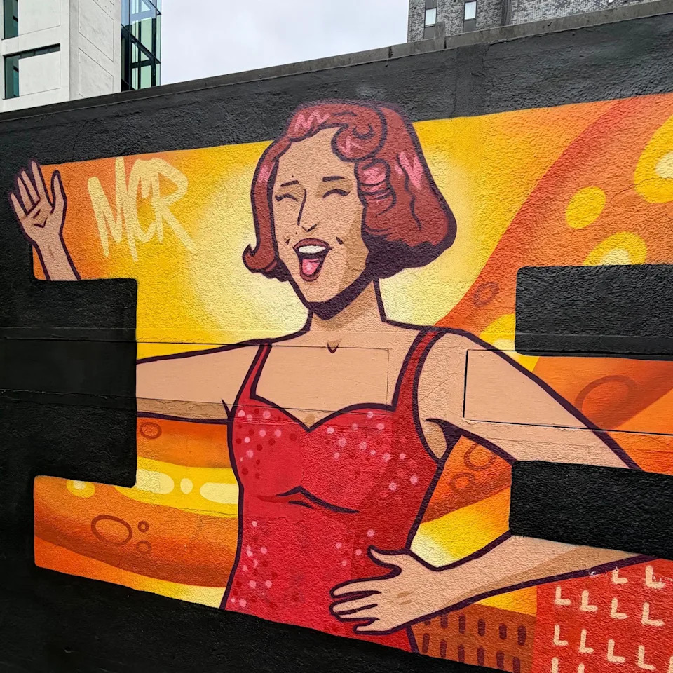 A mural shows pop star Raye in the centre of Manchester 