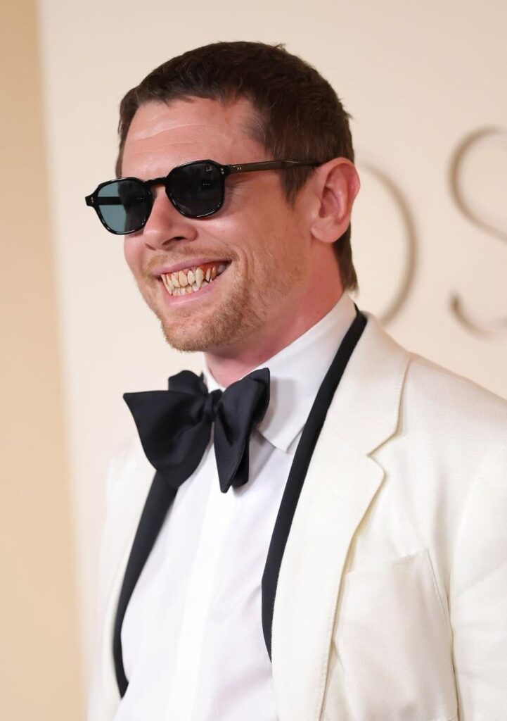 Sinners star Jack O'Connell wearing fangs at the Oscars