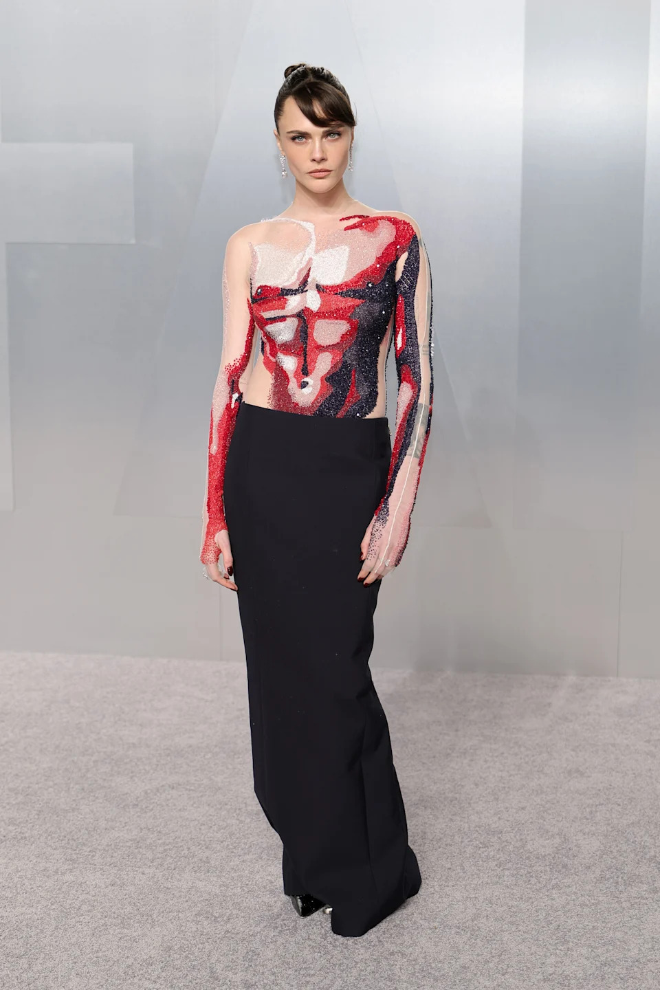 Cara Delevingne attends the 2026 Vanity Fair Oscars Party in a Thom Browne optical illusion dress.