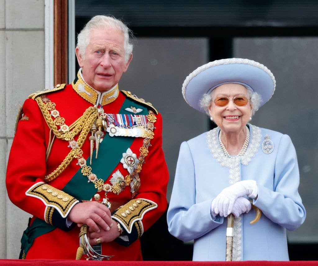 King Charles standing with Queen Elizabeth