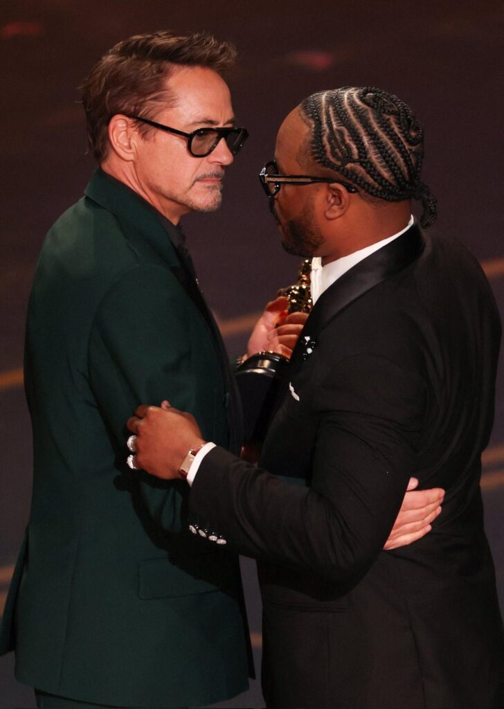 Ryan Coogler Accepts his 2026 Oscar with a Guitar Braided into His Hair