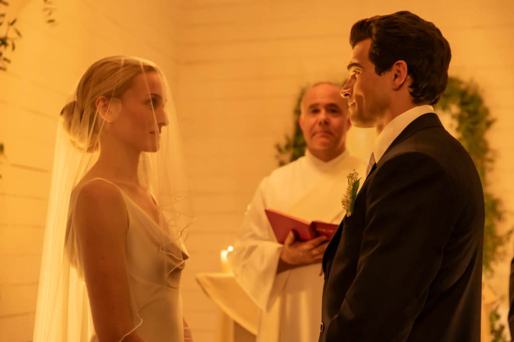 She skipped jewelry in favor of a veil and tulle gloves, pulling her hair back in a bun. FX