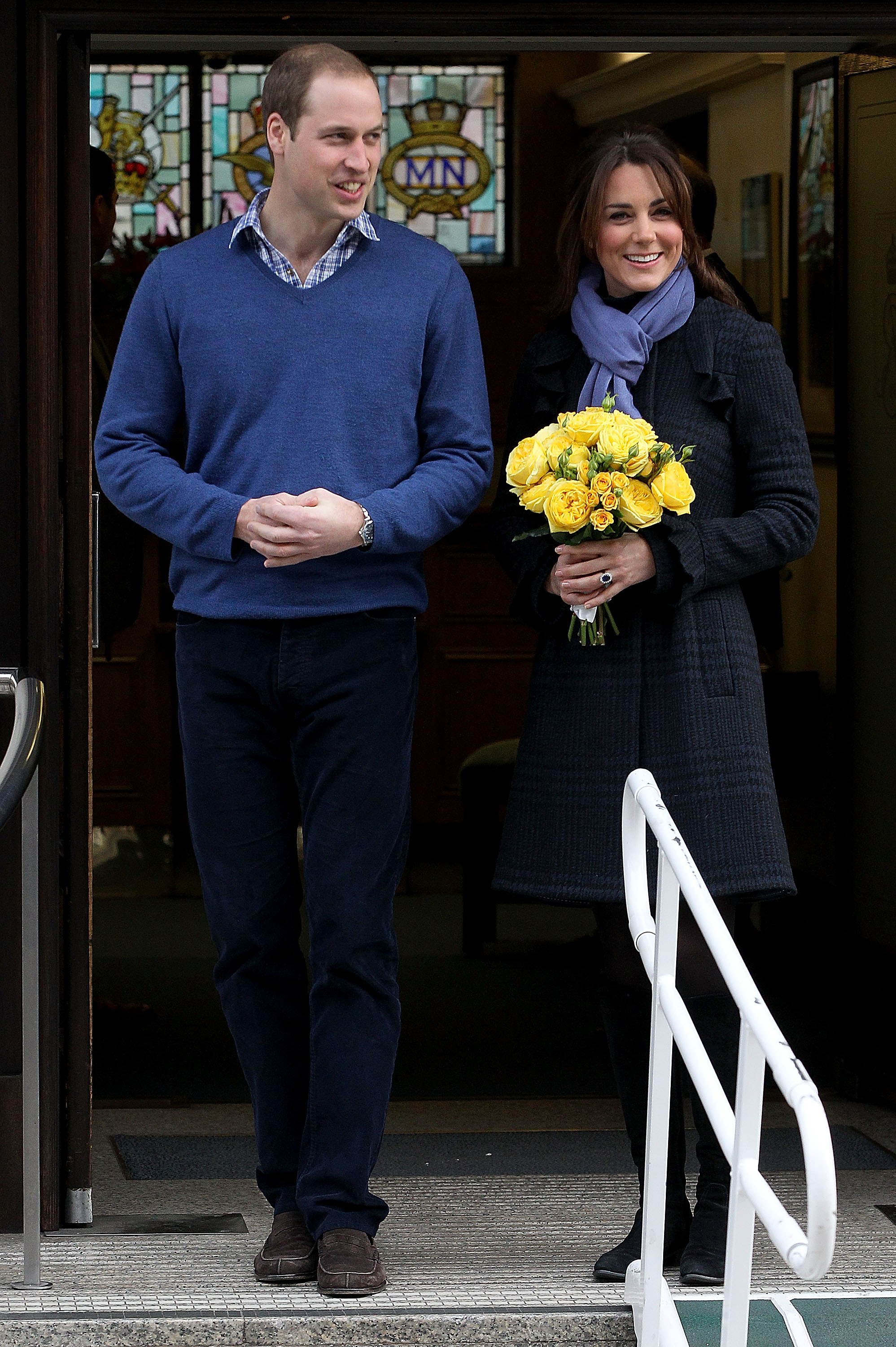 Prince William and Princess Kate leaving the hospital holding yellow roses