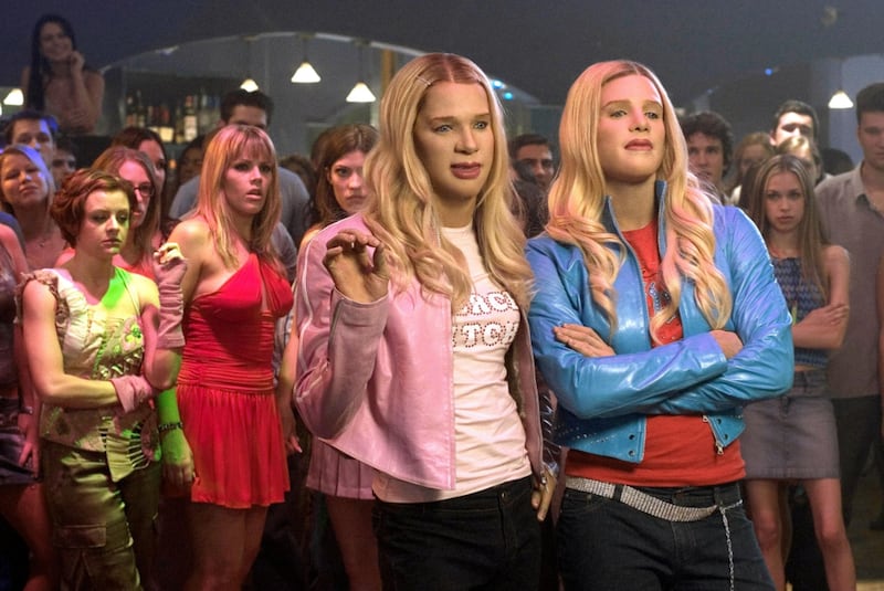 Busy Philipps stands in a red dress behind Marlon and Shawn Wayans in "White Chicks."