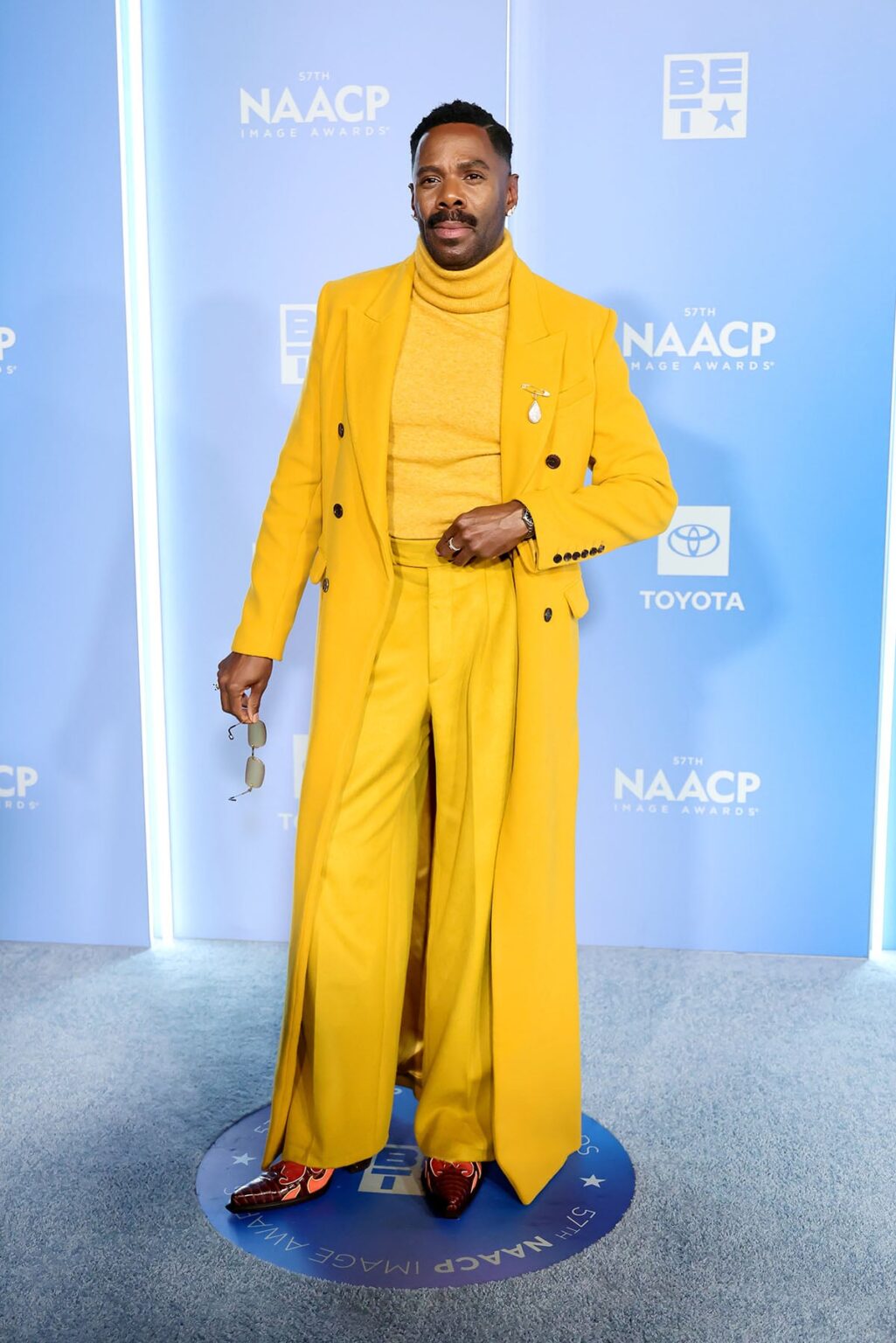 Colman Domingo, Colman Domingo Sergio Hudson, Sergio Hudson menswear, Colman Domingo saffron suit, Colman Domingo NAACP Image Awards 2026, Sergio Hudson gold coat, Colman Domingo cowboy boots, Wayman Bannerman Micah McDonald styling, Boucheron brooch Colman Domingo, NAACP Image Awards menswear