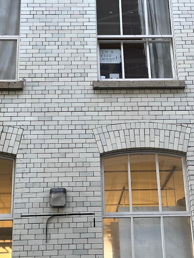 Sign in Conway Mill, Belfast where Kneecap are due to hold a press conference reads: 'I'm a free mawn' Photograph: Seanín Graham