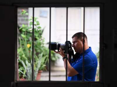 Salvadoran journalist Mario Guevara, 48, deported from the United States, is photographed holding his camera at a family member's house in Apopa, El Salvador, on October 6, 2025.