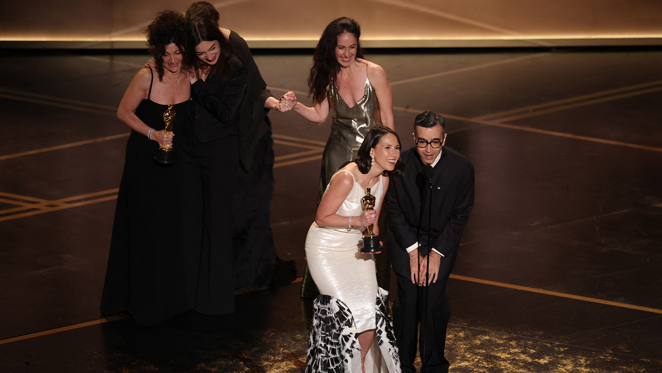 US curator Natalie Musteata and US filmmaker Alexandre Singh accept the Oscar for Best Live Action Short Film for "Two People Exchanging Saliva" onstage during the 98th Annual Academy Awards at the Dolby Theatre in Hollywood, California on March 15, 2026.