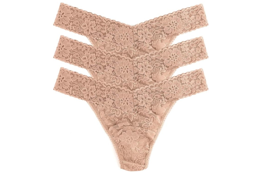 Three pairs of nude lace thong underwear.