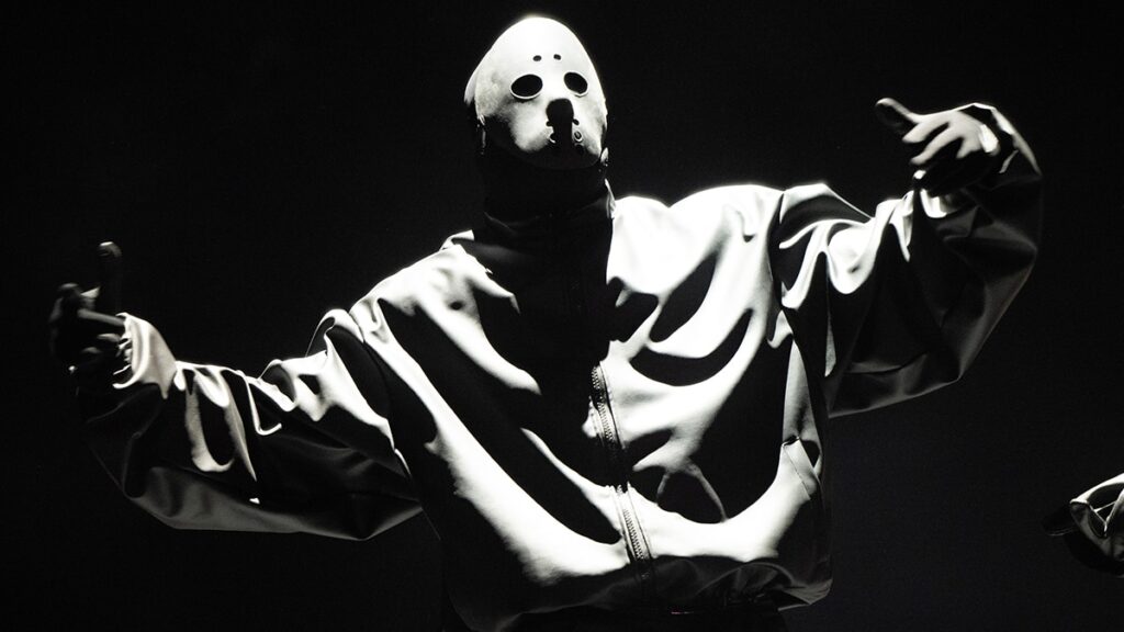 Kanye West performs on stage wearing a hockey mask
