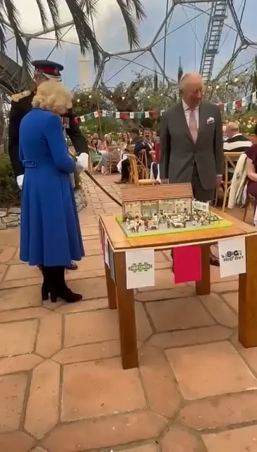 Charles and Camilla cut house-shaped cake with sword borrowed from Lord Lieutenant in Cornwall