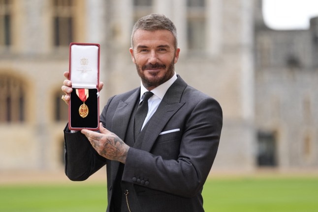 Former England footballer David Beckham poses with their medal after being appointed as a Knight Bachelor (Knighthood) at an investiture ceremony at Windsor Castle on November 4, 2025. (Photo by Andrew Matthews / POOL / AFP) (Photo by ANDREW MATTHEWS/POOL/AFP via Getty Images)