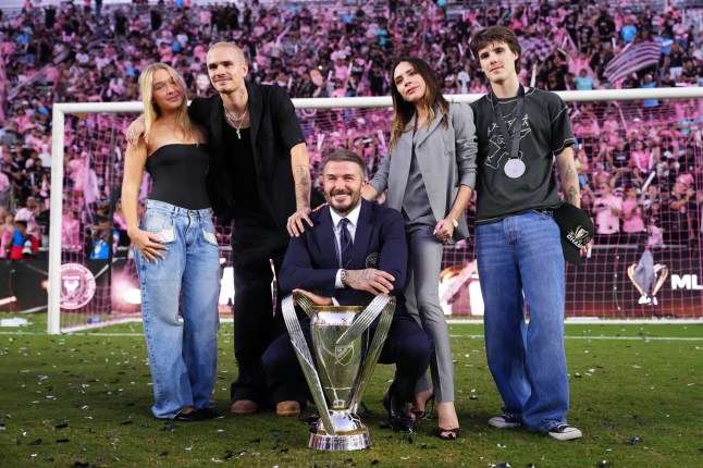 FORT LAUDERDALE, FLORIDA - DECEMBER 06: Sir David Beckham, co-owner of Inter Miami CF, and Victoria Beckham pose with the trophy with Cruz Beckham, Romeo Beckham after winning the Championship following the Audi 2025 MLS Cup Final match between Inter Miami CF and Vancouver Whitecaps FC at Chase Stadium on December 06, 2025 in Fort Lauderdale, Florida. (Photo by Rich Storry/Getty Images)