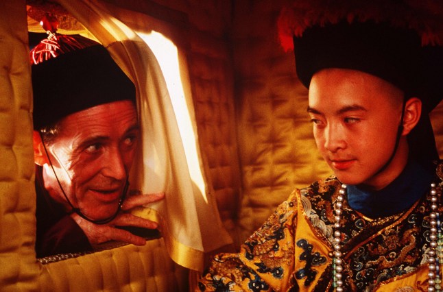 Peter O'Toole peeks through a curtain into a carriage containing Wu Tao in a scene from The Last Emperor