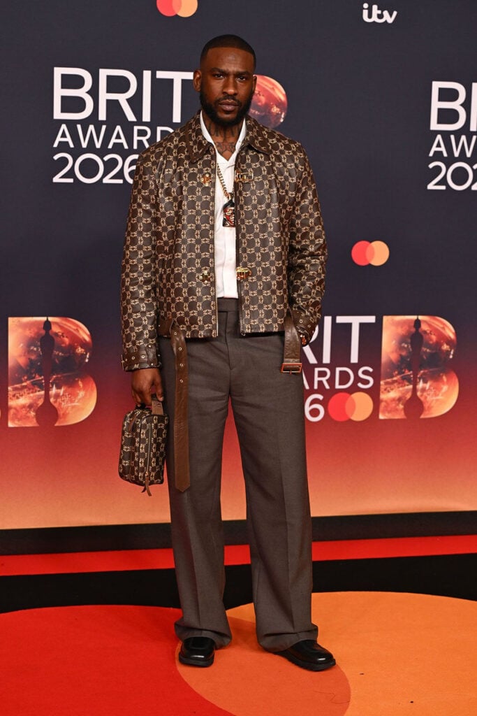 Skepta BRIT Awards 2026, Skepta Mains Spring 2026, Skepta Mains label, Skepta monogram jacket, Skepta red carpet style, Mains fashion brand
