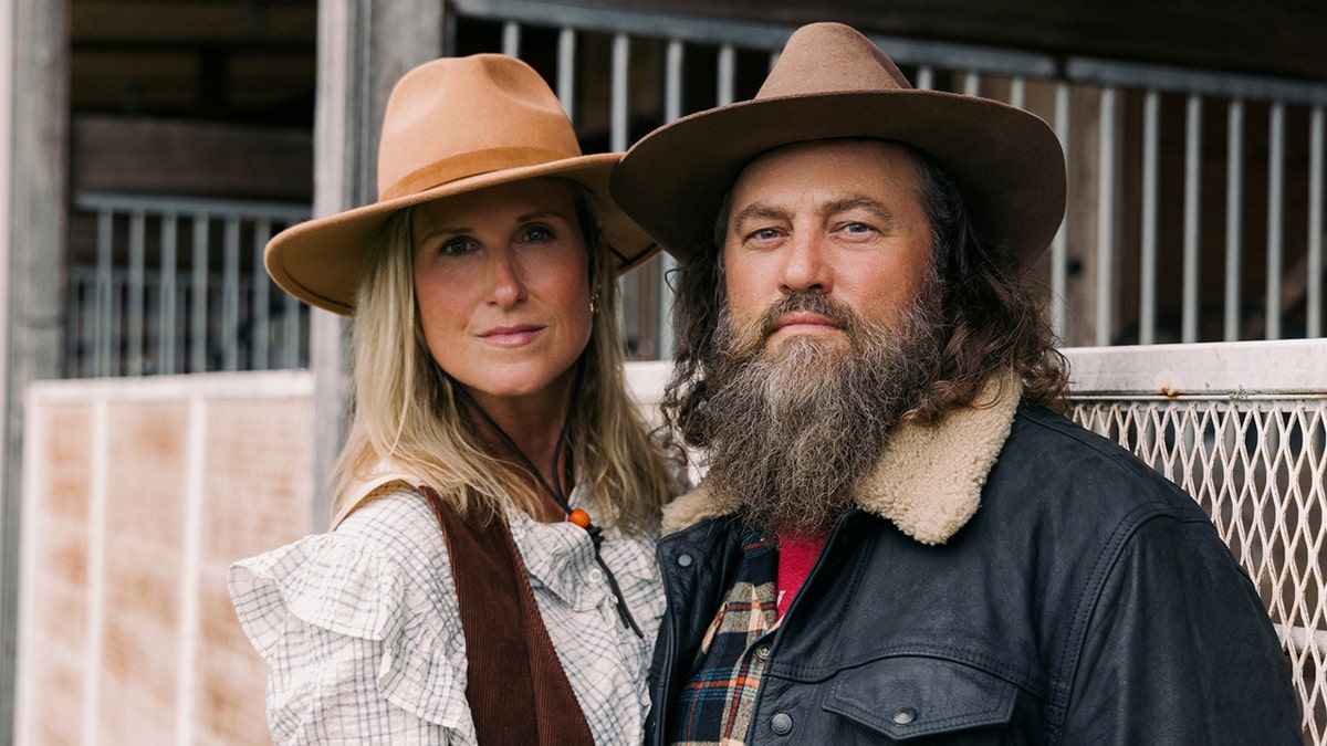 Willie and Korie Robertson look at the camera in western clothing for a promo photo for their new season of Duck Dynasty: The Revival.