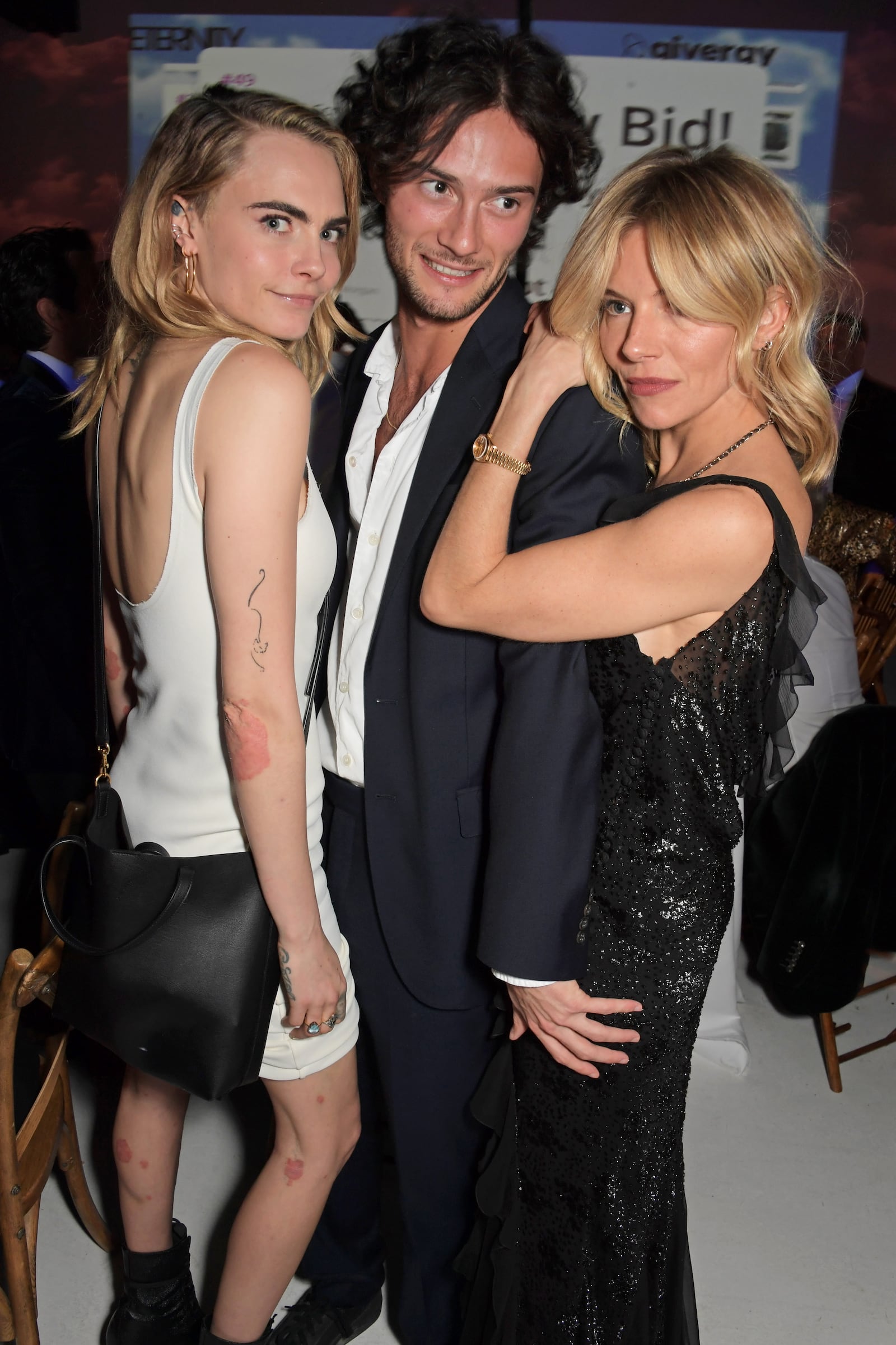 Supermodel Cara Delevingne with Oli Green and Sienna Miller at The Eternity Charity Fundraiser in London in May 2022.