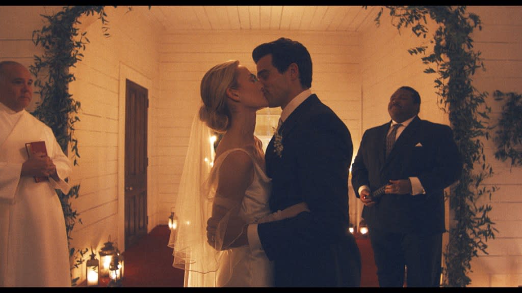 The simple yet elegant choice was decidedly bold for a bride at the time. FX