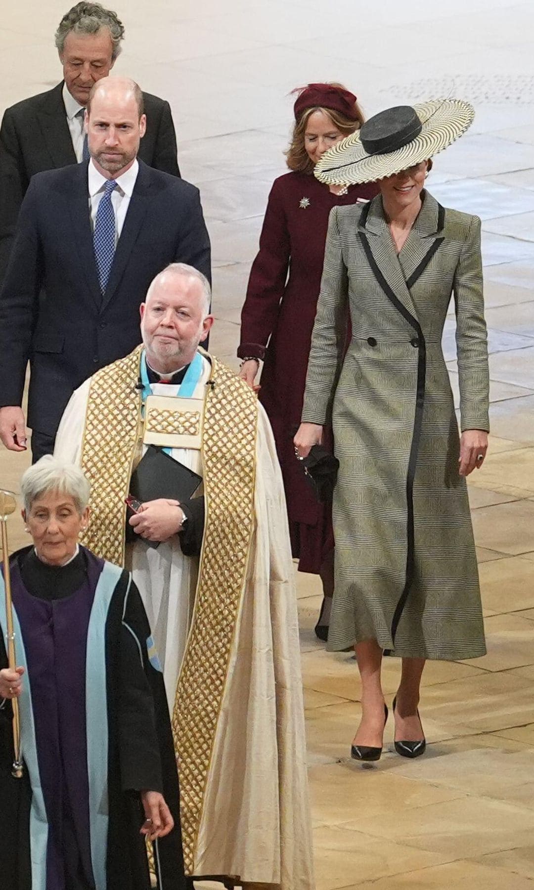 Kate Middleton's sculptural piece, finished with a single ostrich quill, added both height and drama without overwhelming the tailored coat beneath.