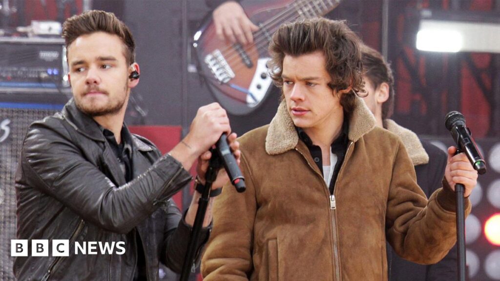 Harry Styles opens up about impact of Liam Payne’s death Liam Payne and Harry Styles performing together on stage. The pair both wear black and white suits and there is a band behind them