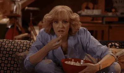 Woman eating popcorn in a GIF