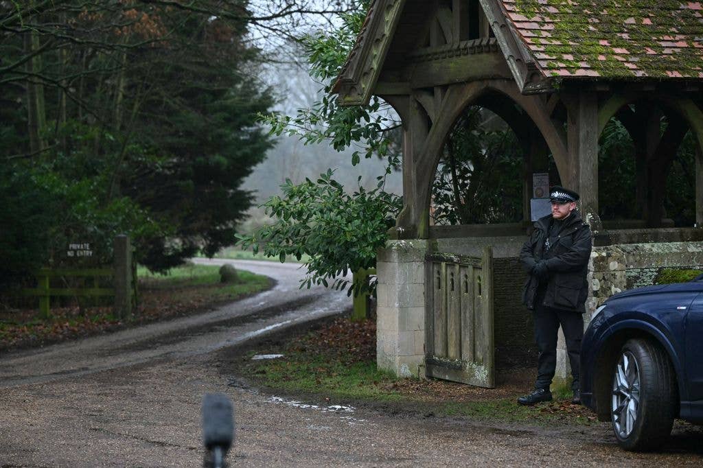A policeman stands at an entrance to Wood Farm on the royal family's Sandringham Estate in Norfolk, eastern England on February 19, 2026, where former prince Andrew was arrested earlier in the day
