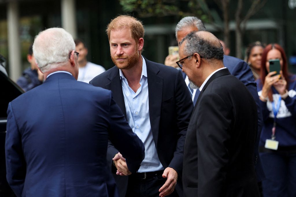 Prince Harry shaking hands during a visit to London