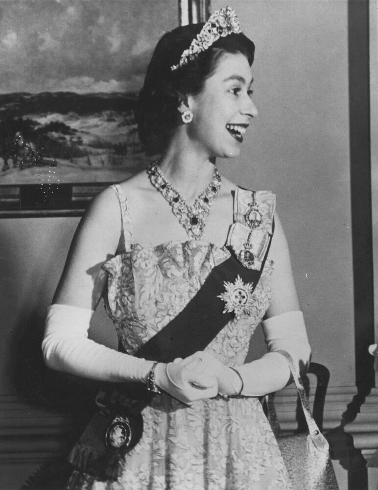 formal portrait of a woman wearing a decorated gown and jewelry