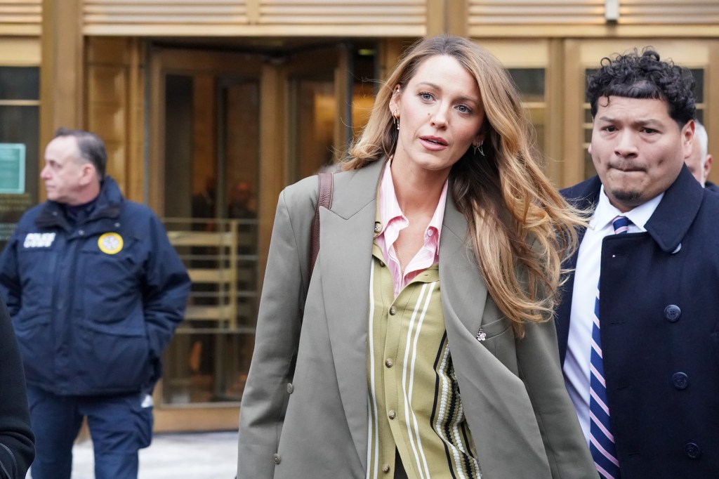 Blake Lively exiting Federal Court, with two men standing behind her.
