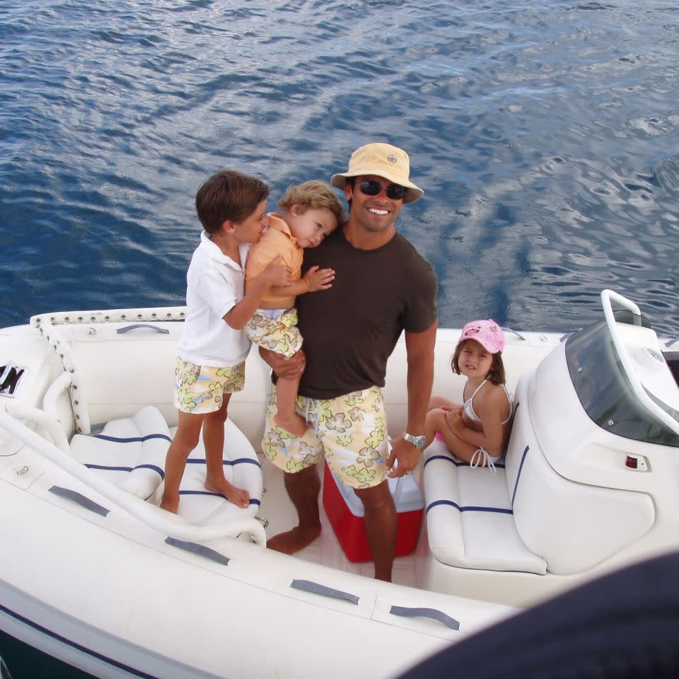 Mark Consuelos with his kids Michael, Lola, and Joaquin on a boat in the early 2000s.Credit: Lola Consuelos/Instagram
