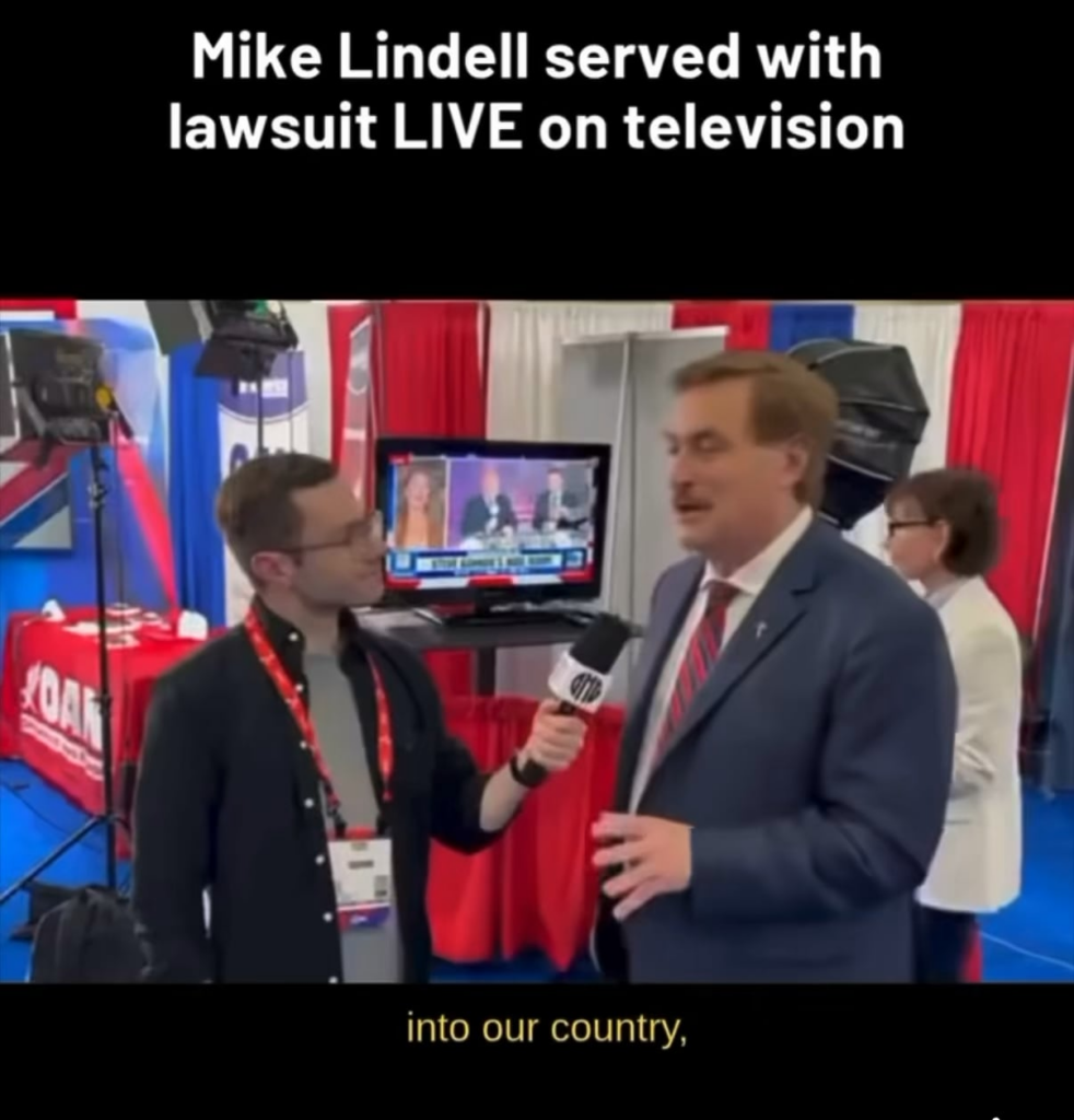 Mike Lindell getting served papers while doing an interview