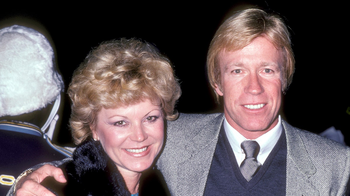 Chuck Norris embracing his first wife during a night out.